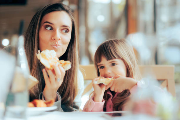 Mom and child eating pizza